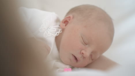 newborn baby girl asleep while in her crib