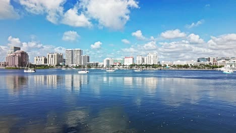 aerial: cityscape with one flagler, marina and phillips point building in west palm beach, florida, usa, establishing drone shot