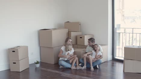 parents and two daughters discussing furniture arrangement