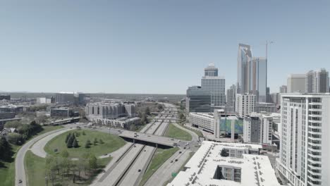 Clear-blue-sky-over-busy-Interstates-and-Highways-of-Charlotte-with-Skyscrapers-and-buildings