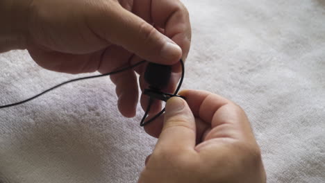 a man loops a lapel mic