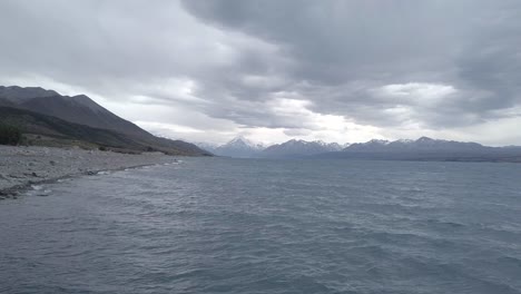 Aerial-Above-Rough-Waters-with-Mountains-in-the-Distance