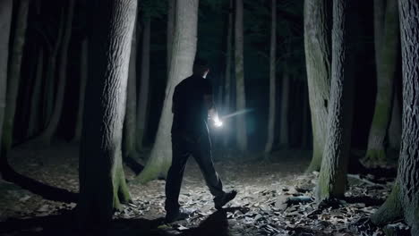 man hiking in the dark forest