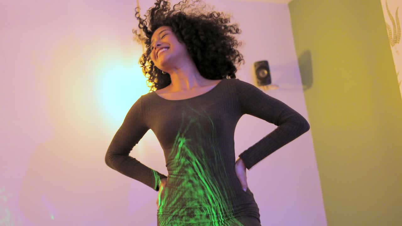 Sensual woman dancing at home in a party with friends