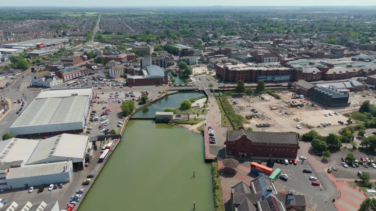 Aerial drone footage of Grimsby harbour and Chamber of Commerce building surrounded by busy industrial warehouses and export cargo in Lincolnshire England