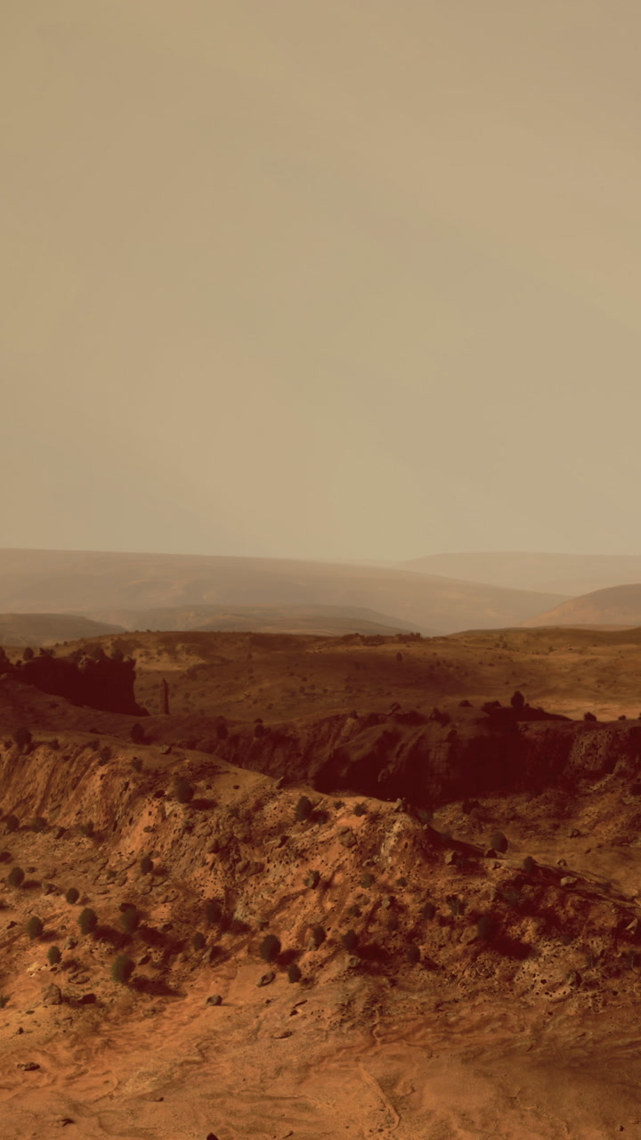 Red landscape with distant hills and clear sky captured in daylight