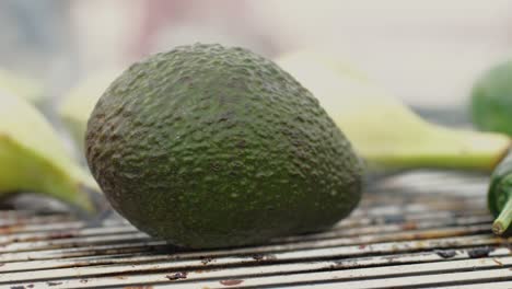 grilled banana on fire, latin american vegan grill with avocado and pepper, thai or ecuadorian street food. african traditional food on grill.
