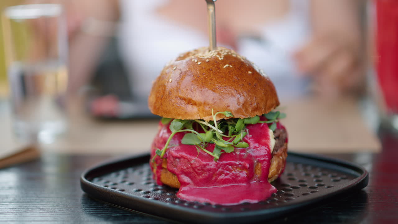 Close up burger with red sauce and green salad microplants