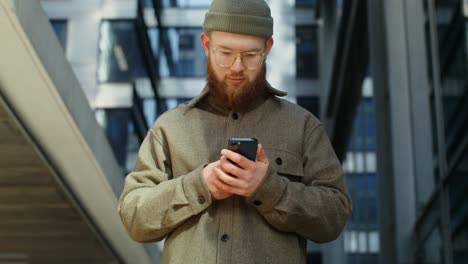 man using smartphone in a city