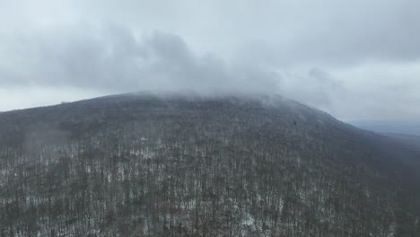 drone flight video as it approaches a cloud covered mountain