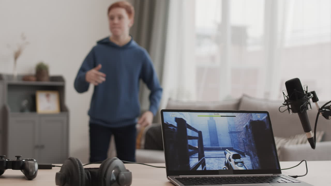 Teenage boy playing video game at home