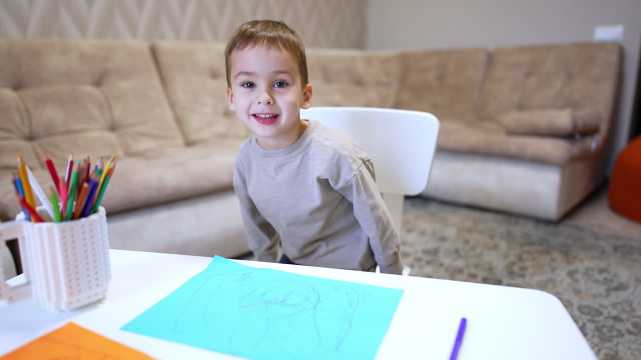 Child drawing with crayons in cozy room. A young child focused on drawing at a white table in a warm, inviting living space. Crayons are neatly arranged