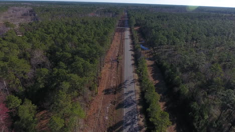 An-aerial-shot-of-a-back-road-that-stretches-far-into-the-distance