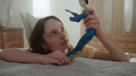 a girl playing with dolls in her room