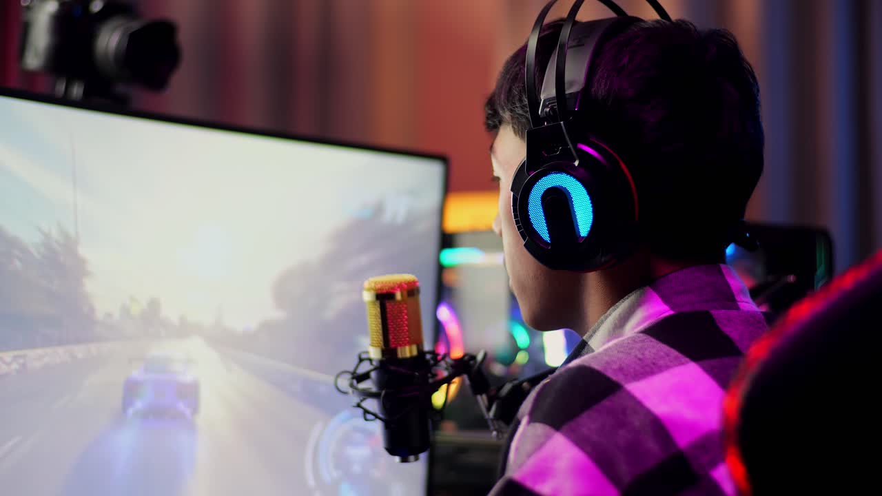 Close Up Back View Of Asian Boy Streamer Screaming Goal Celebrating Winning Car Racing Game Over Network On Personal Computer.  Live Stream Video Game, Desk Illuminated By Rgb Led Strip Light