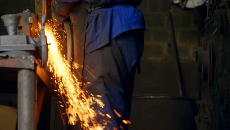 Male-worker-using-grinder-machine-in-workshop-4k