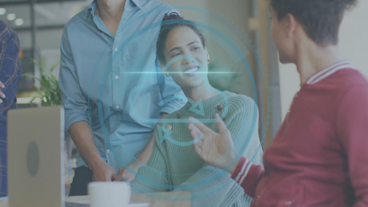 Man in red speaking and gesturing showing cybersecurity HUD on laptop, woman smiling then laughing