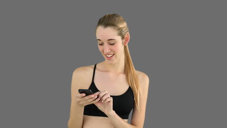 fit model texting on her phone