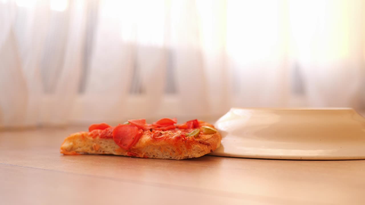 Pizza Slice on Table with Empty Plate