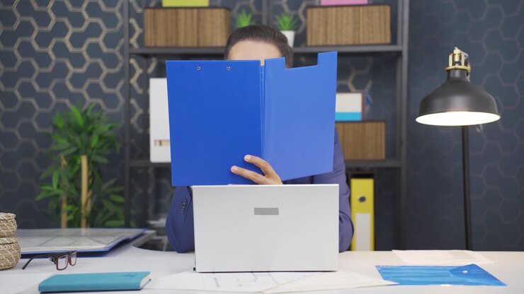 Cheerful businessman working on files.