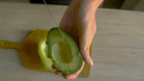 white woman cutting avocado