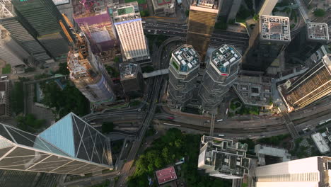 the lippo towers and bank of china, cinematic drone flyover shot during golden hour