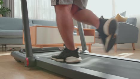 person running on treadmill at home