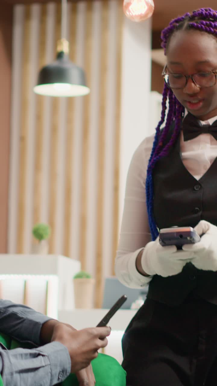 Vertical video Man does mobile payment at pos