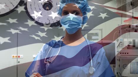 animation of flag of united states of america waving over surgeons in operating theatre