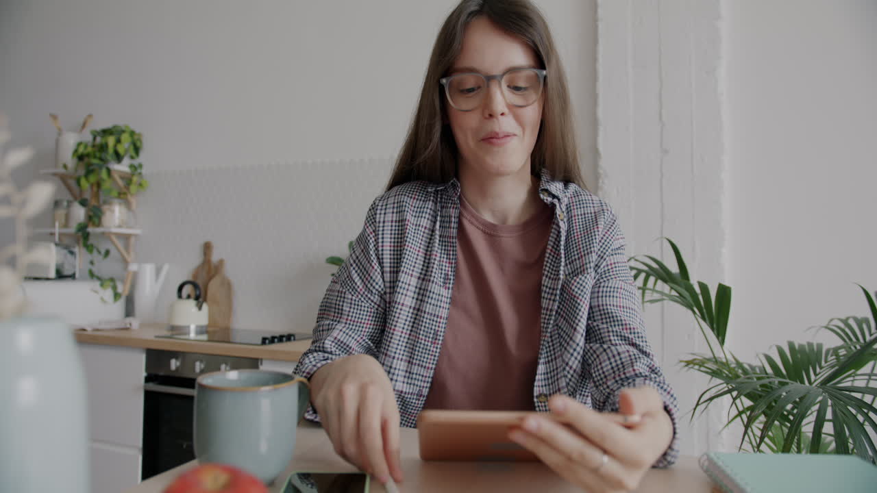 Woman having a video call in her kitchen