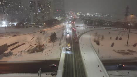 multiple winter service vehicles plowing streets at night, aerial shot