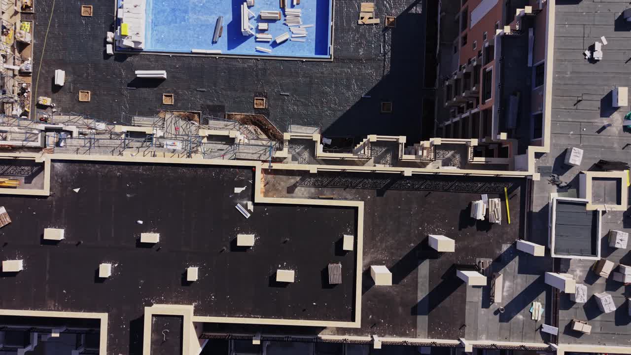 Aerial View of a Large Construction Site with Buildings and Crane