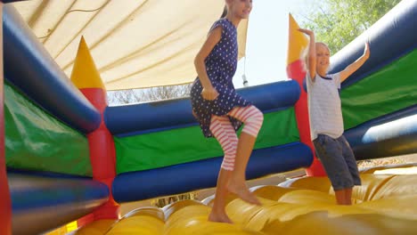 kids playing on the bouncing castle 4k