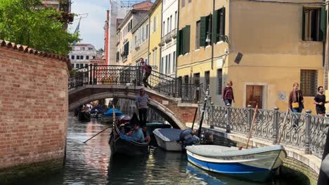 romantic and traditional gondola boat ride on venice canal waterway by a gondolier in italy