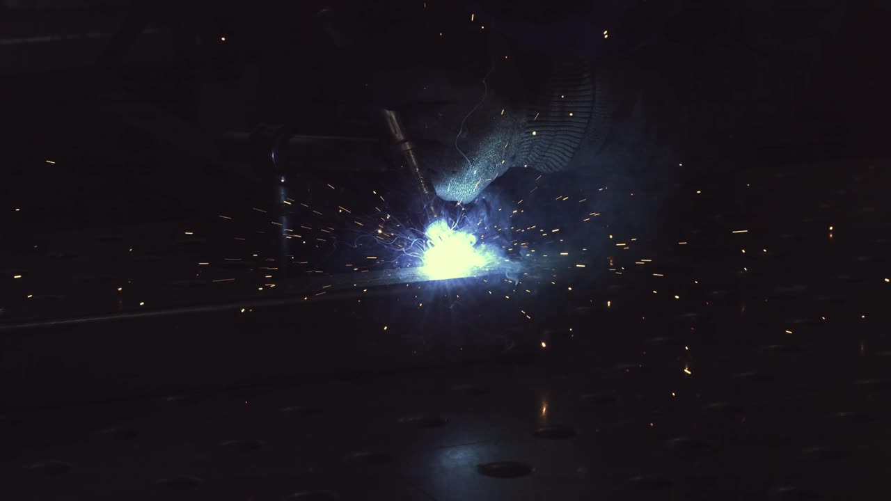 Man is welding steel pipes in super slow Motion