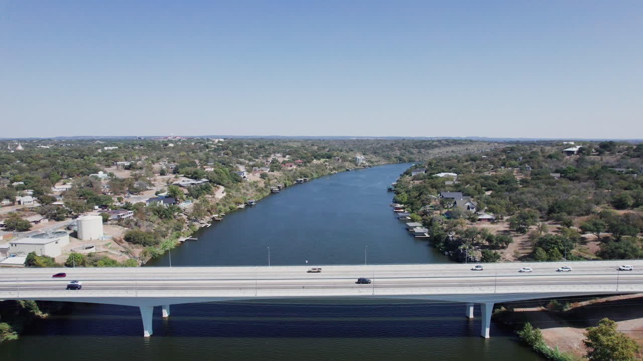 Drone shot pulls back on Lake LBJ and the Highway 281 Bridge in Marble Falls, Texas in the Hill Country