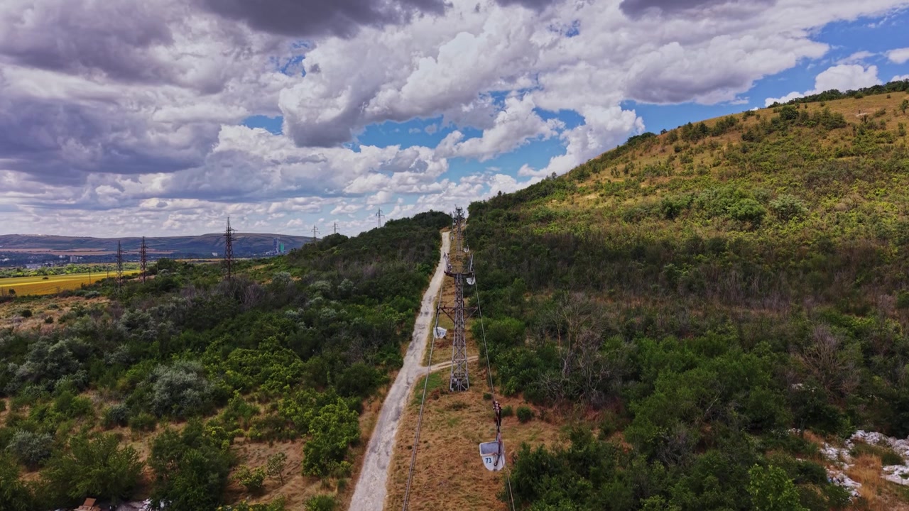 Funivia sale su una collina in una zona rurale con tempo nuvoloso