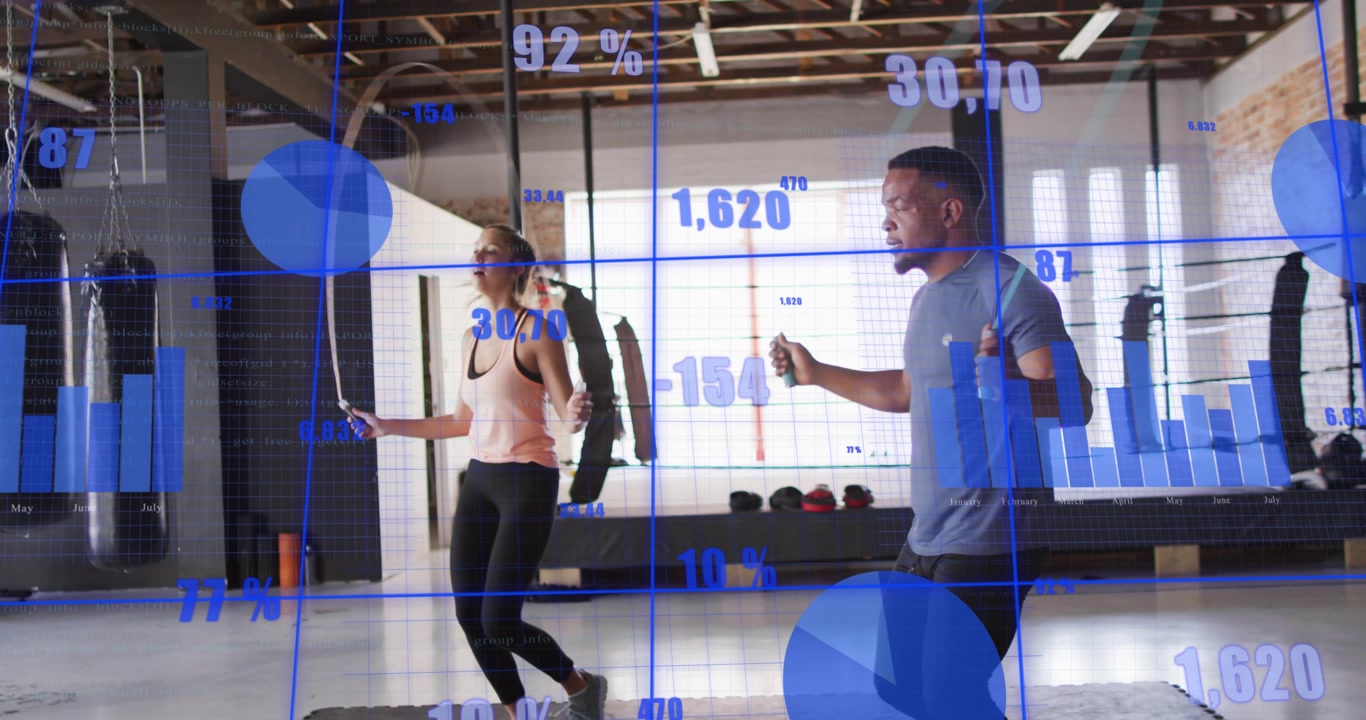 Fitness partners starting jump ropes together on mat, blue charts tracking stats, ropes lowering