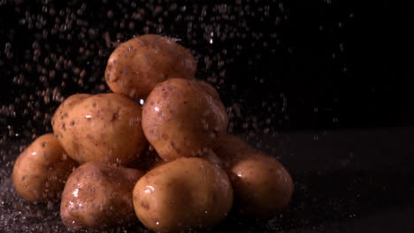 water raining on pile of potatoes