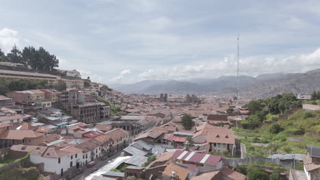 upwards moving drone shot above cusco peru on a cloudy day away from the city center log