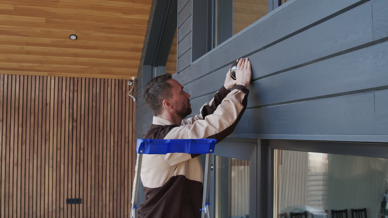 Handyman Installing Home Security Camera