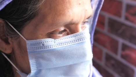 close-up portrait of an elderly woman wearing a face mask