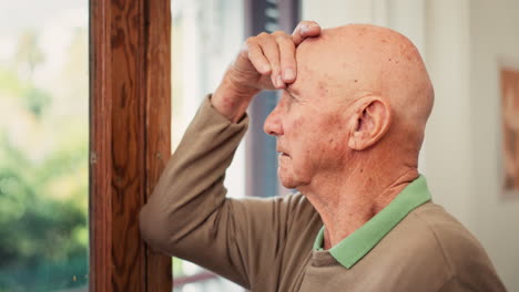 Senior-man,-anxiety-and-thinking-by-window