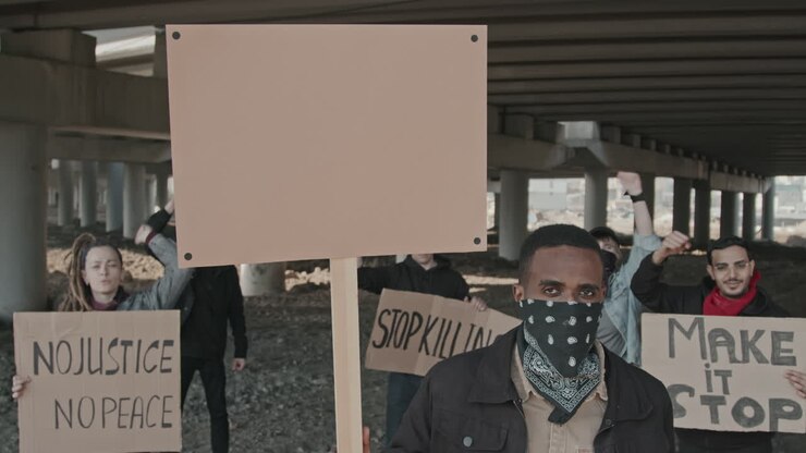 Protesters Holding Signs at a Demonstration