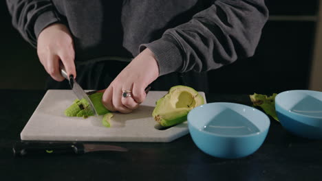 woman chopping avocado