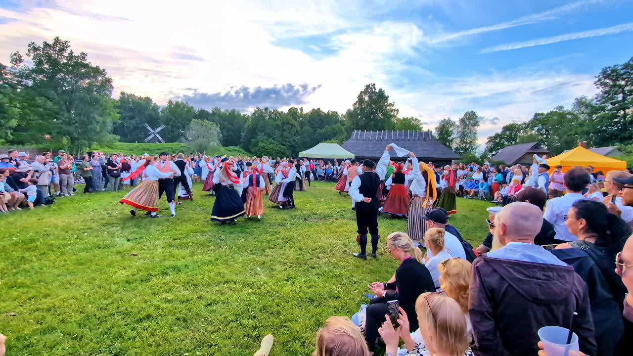 Dance performance in traditional dresses at midsummer festival