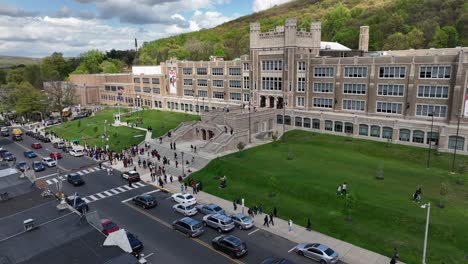 aerial view of a bustling school campus with students and cars