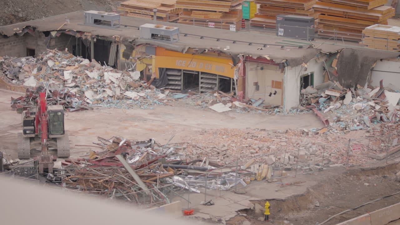 Slow motion footage of a demolished store covered in rubble.