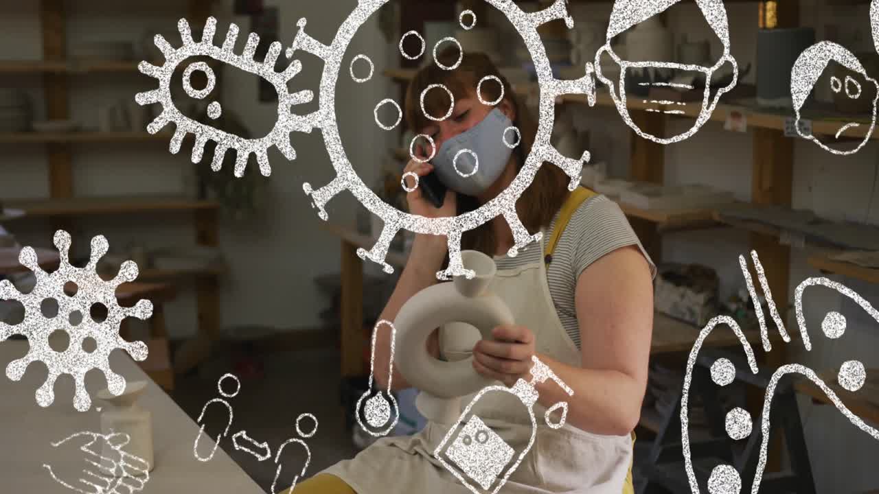 video compuesto de iconos de concepto de covid-19 contra una mujer con máscara facial sosteniendo un objeto de cerámica