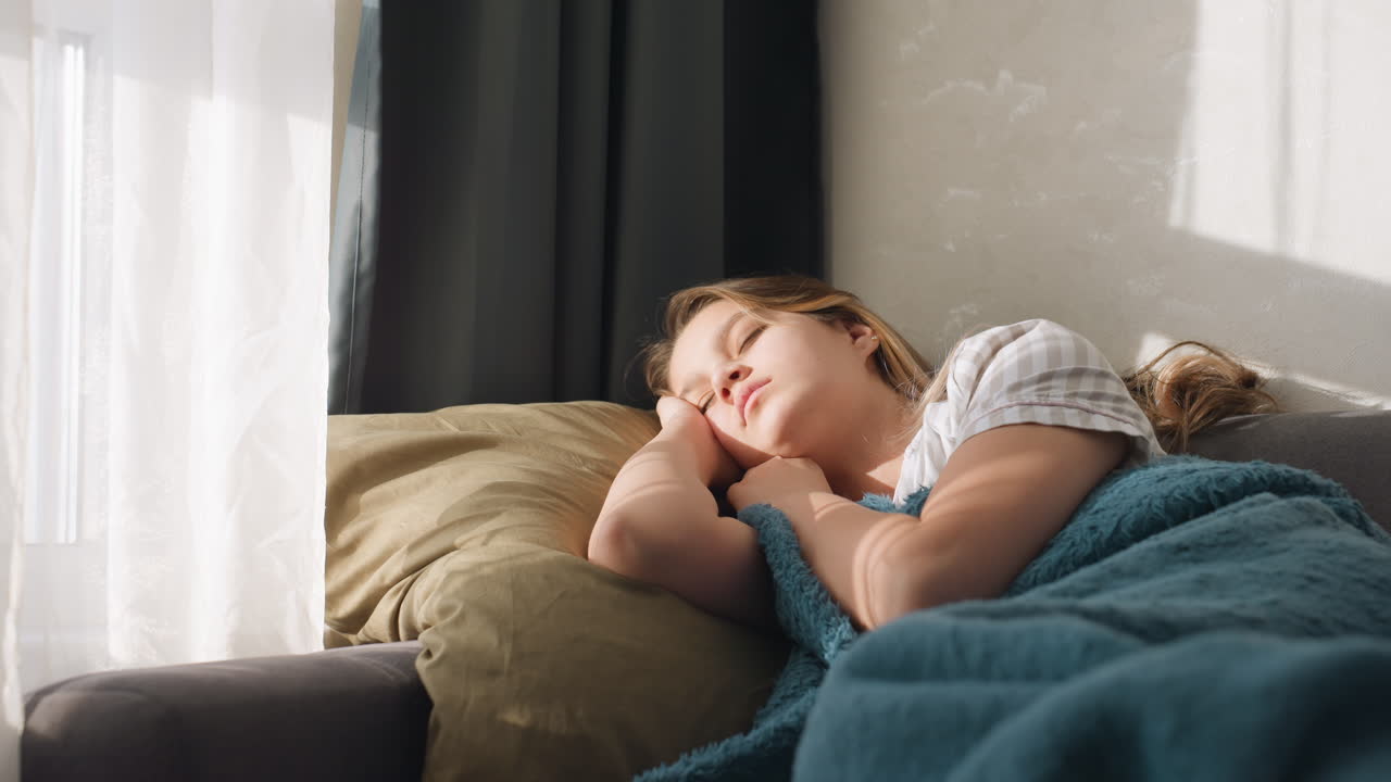 Peaceful Lady Relaxing Under Warm Sunlight, Calm Woman Enjoying Soothing Sunlight Beneath Cozy Blanket, Gentle Afternoon Scene With Woman Peacefully Resting Outdoors In Soft Sunlight And Shade